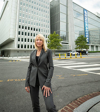 Elise Miller-Hooks in front of a street with a tall building behind it. 