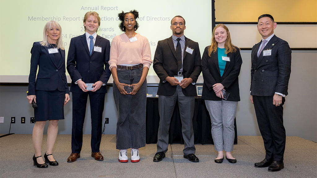 A diverse group of students receiving their awards