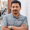 Kaustubh wears his company's work shirt