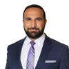 Soroush Yazdi with a blue suit and striped tie